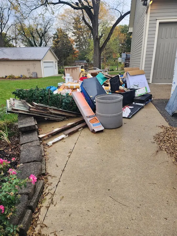 Dumpster being loaded with debris for Residential Dumpster Rental in Cave Springs